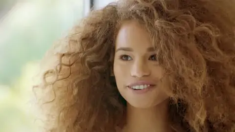 Nubile dark-hued with wavy hair is railing a phat boner on the bed